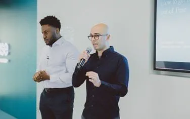 Two young men hosting a Fuse presentation
