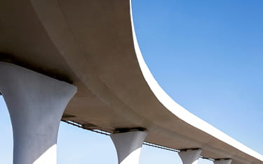 A curved bridge against a blue sky