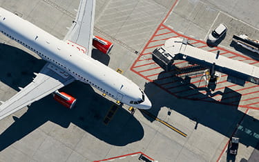 View of aeroplane from above, on tarmac at an airport gate