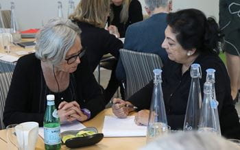 image of 2 women sitting at a table chatting
