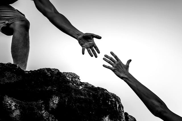 two hands reaching out together 