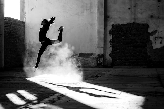 A person dancing in an empty warehouse 