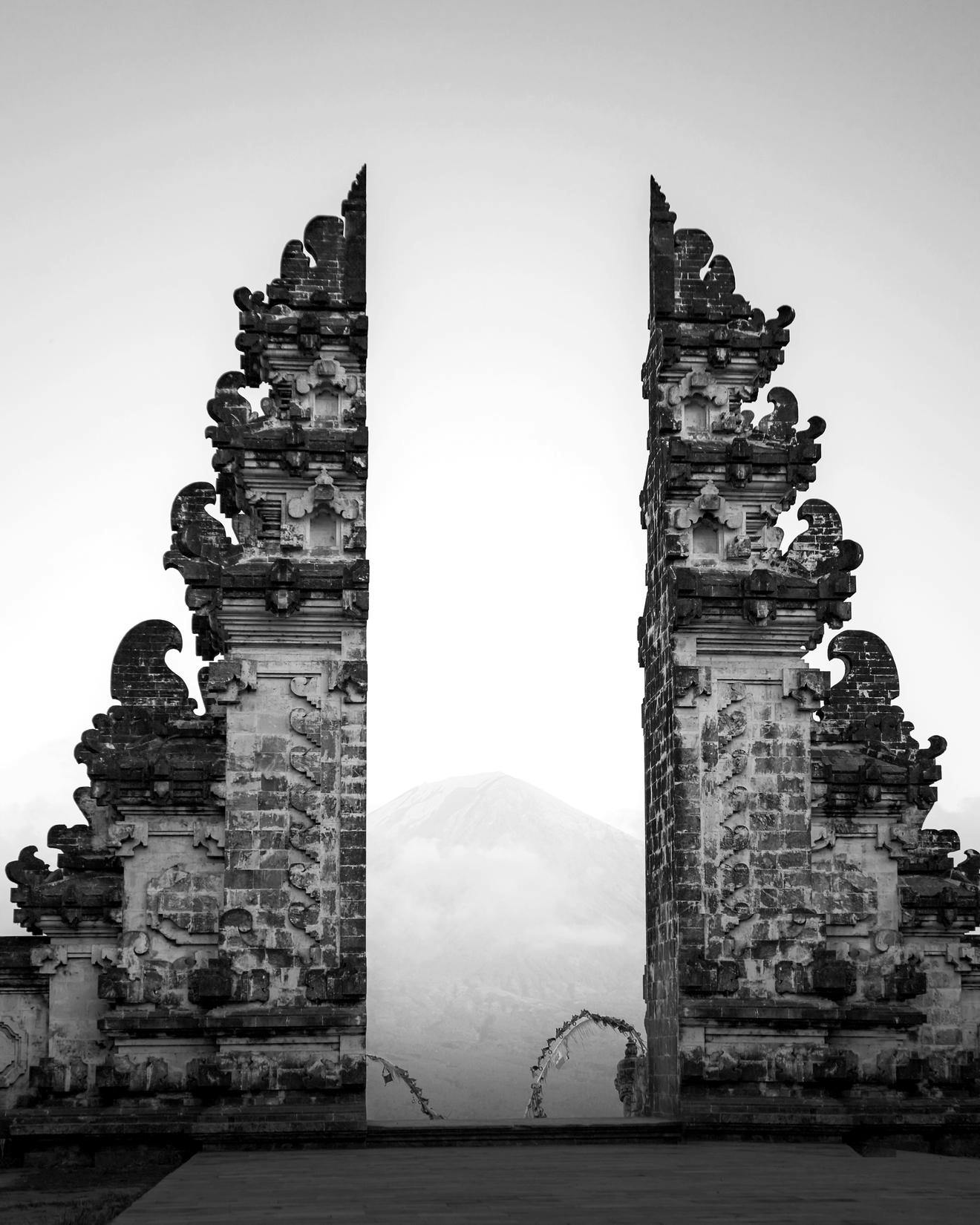 Black and white image of a stone temple gate in Indonesia