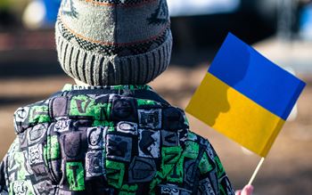Image of child holding Ukraine flag