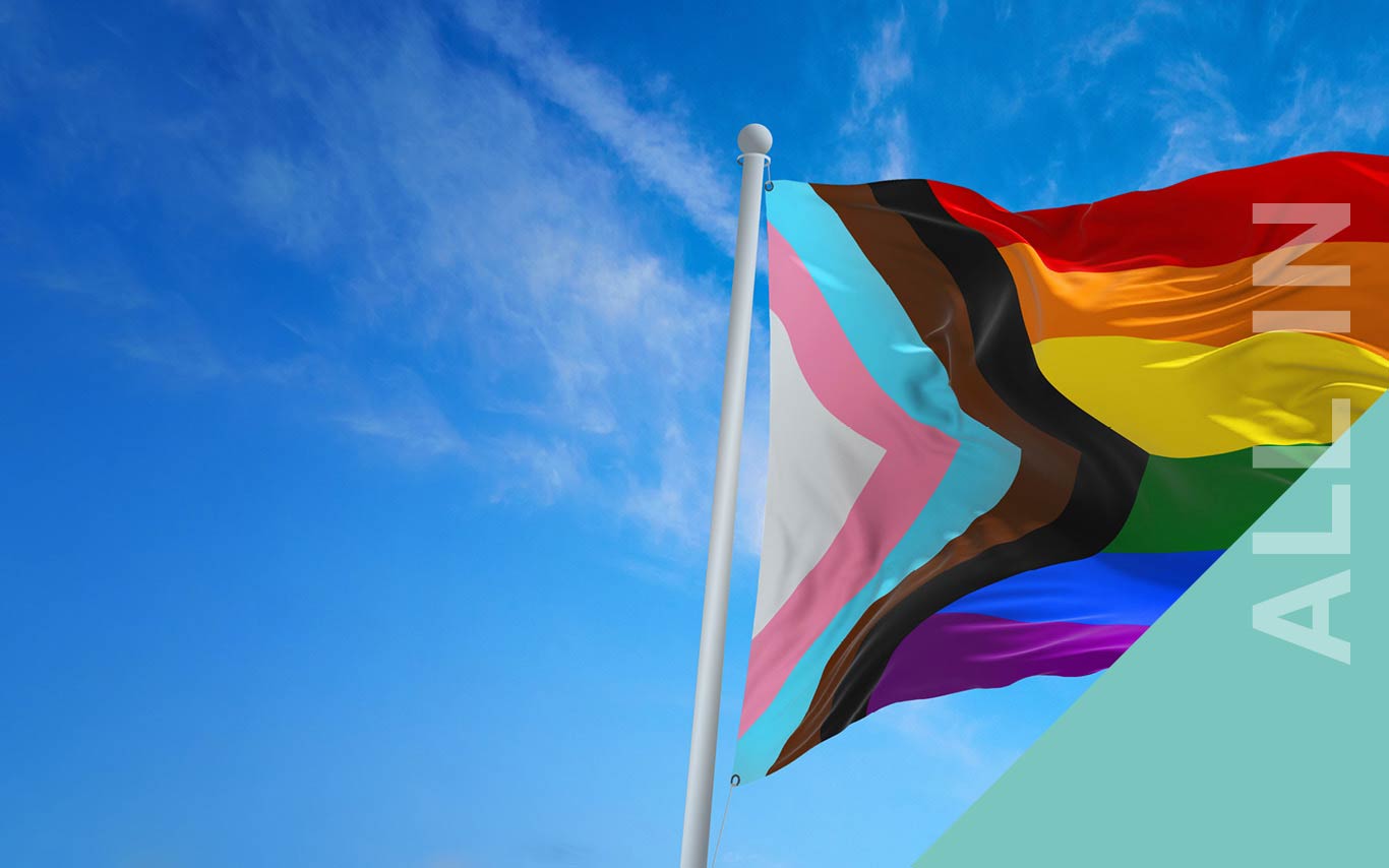Image of Pride flag against blue sky