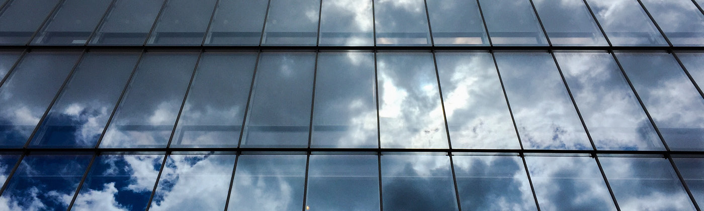 Dark sky reflected on glass highrise building
