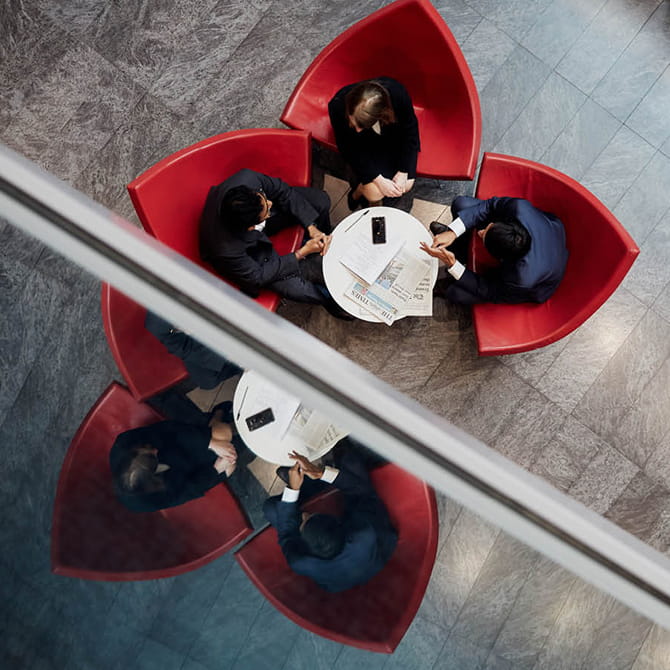 Four young professionals sitting around a table in a work setting