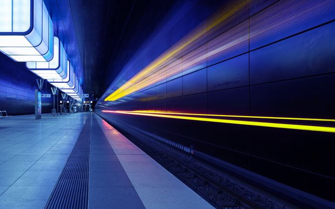 blue and yellow light trails in underground station