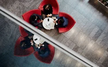 Aerial view of people sitting at desk