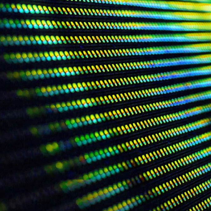 Computer circuit board reflecting green, blue and yellow light