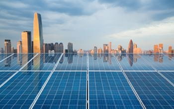 Solar panel with city buildings in background