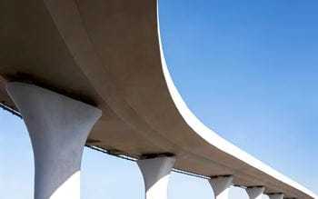 A curved bridge against a blue sky