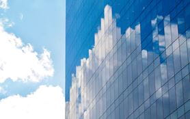 Glass building, reflection of clouds 