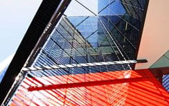 Exterior of a modern red metal and glass building
