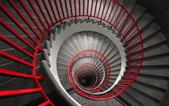 Bird's eye view of a modern red and black spiral staircase
