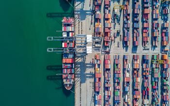 Aerial view of busy port with many shipping containers