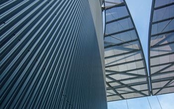 Modern glass building against a blue sky