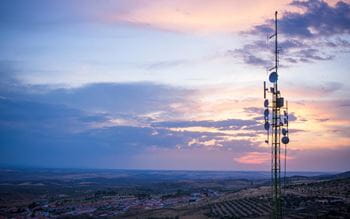telecomms tower in front of an evening sky 