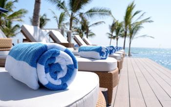 sunbeds by the sea with beach towels