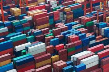 Dozens of brightly coloured shipping containers stacked up