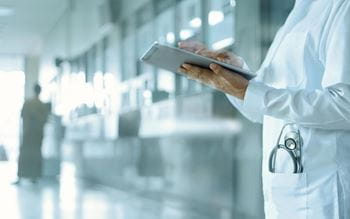 A doctor using an iPad