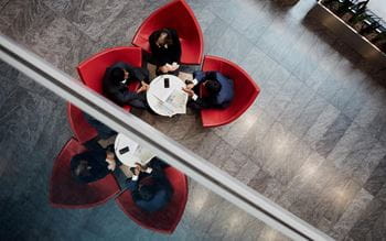 Aerial view of people siting around a coffee table
