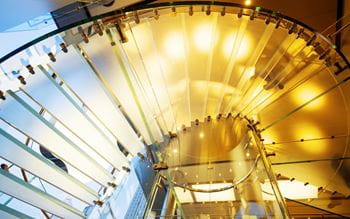 glass spiral stair case in a building