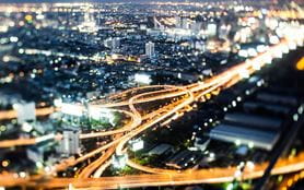 An aerial view of a busy city road network at night
