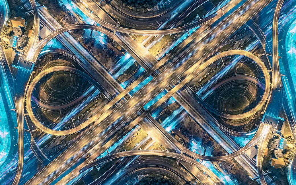 A busy road junction illuminated at night