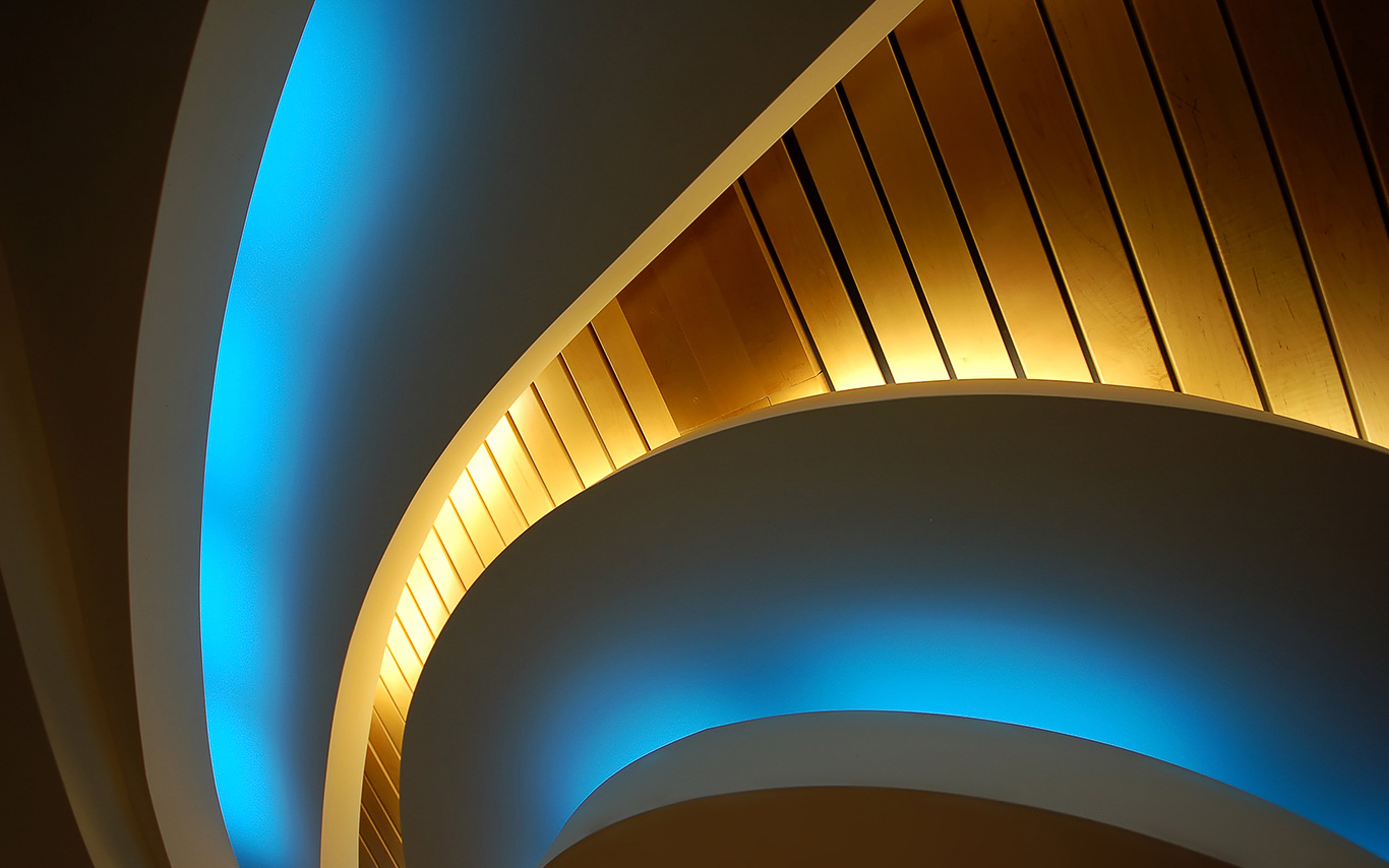 An illuminated modern spiral staircase