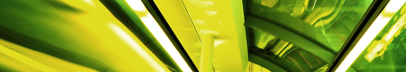 image of bright green downward escalator