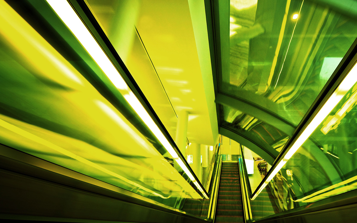 neon green downward escalator image