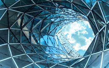 Cloudy blue sky seen through a hole in the middle of a sculpture