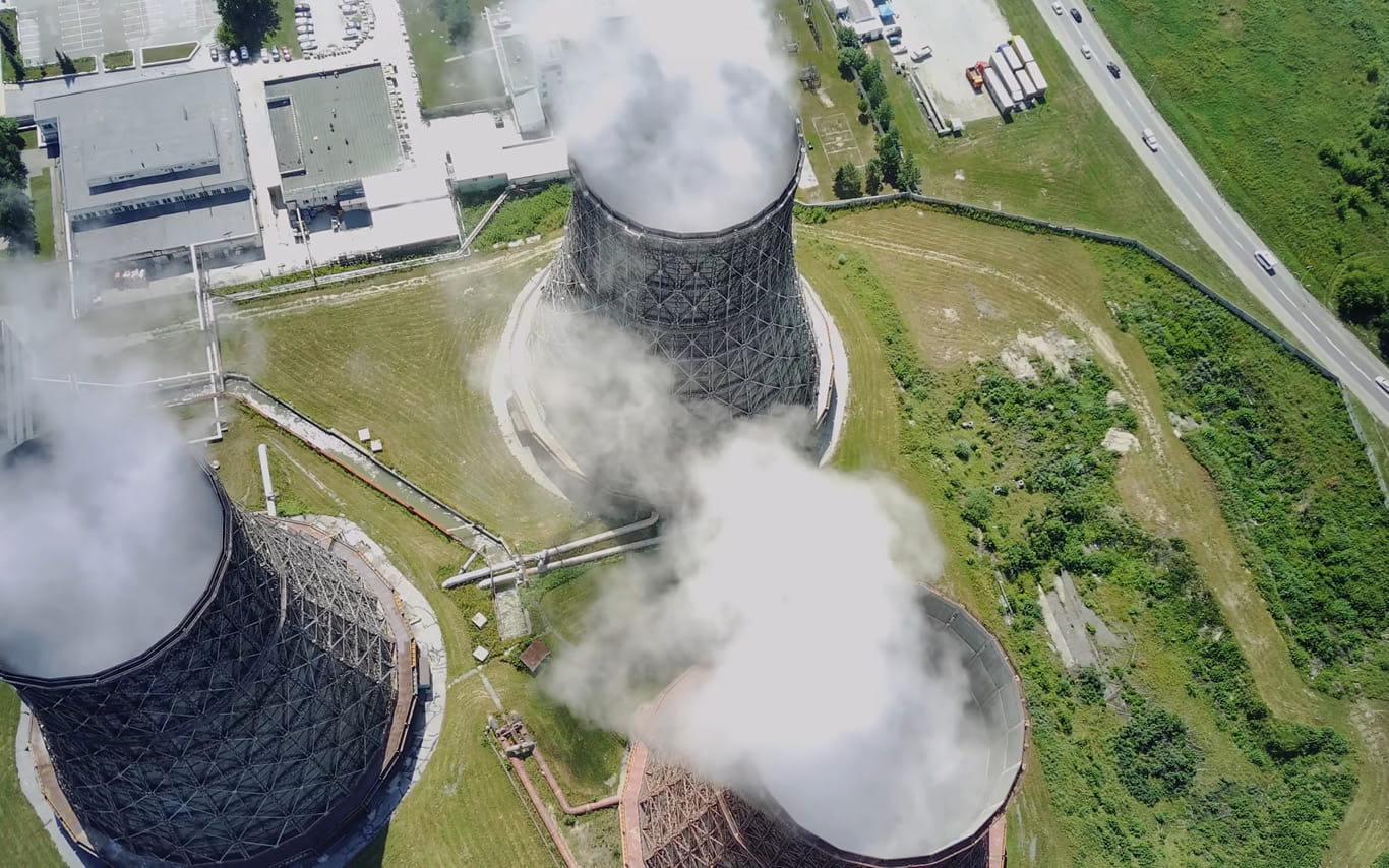 Aerial view of large nuclear power plant chimneys