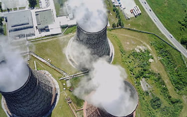 Aerial view of large nuclear power plant chimneys