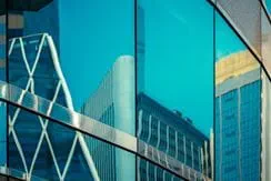 Large buildings in the reflection of a glass window