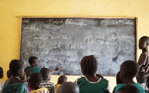 Children sat around a blackboard
