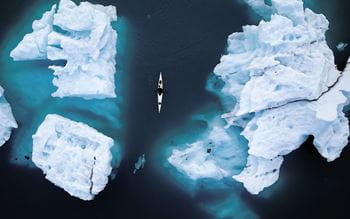 Image of person sailing through ice sheets