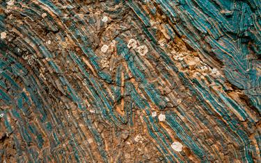 Extraction of minerals for heavy industry - the texture of the rock containing iron ore and copper.