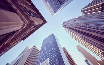 Vertical  perspective of high rise buildings with blue sky background