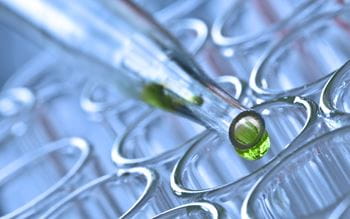Green liquid being dropped into test tube